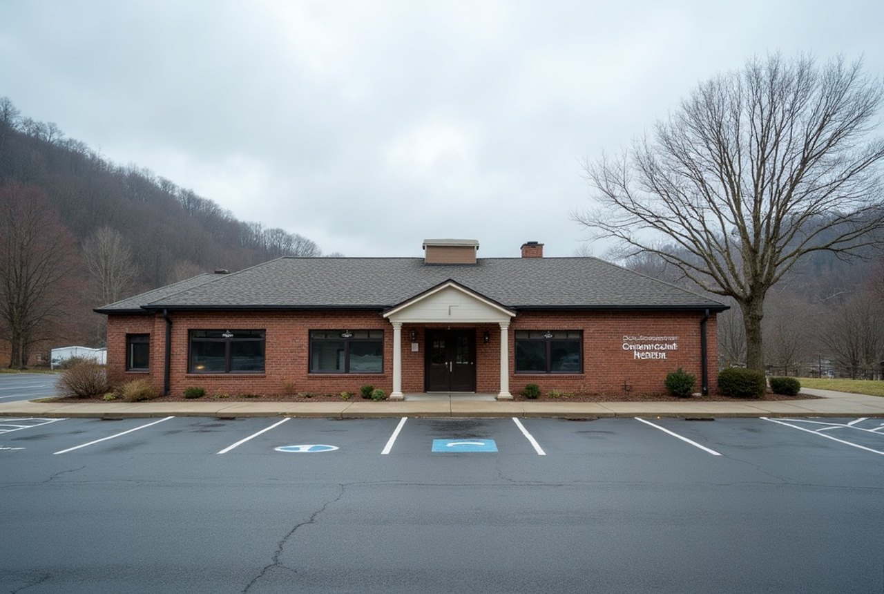 A small rural Pennsylvania hospital building seen across an empty parking lot, overcast, editorial